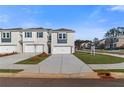 Charming townhome featuring a two-car garage, well-manicured lawn, and contemporary architectural design in a vibrant community at 200 Sanctuary Dr, Mcdonough, GA 30253