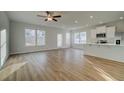 Bright open-concept living area featuring hardwood floors, recessed lighting, and modern fixtures, perfect for entertaining at 200 Sanctuary Dr, Mcdonough, GA 30253