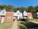 Well-maintained townhomes showcasing brick and stucco facades, accented by lush green lawns at 3589 Main Station Sw Dr, Marietta, GA 30008