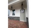Charming front porch with brick flooring and stylish hanging lanterns at 273 Lakeside Pl, Canton, GA 30114