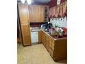 Functional kitchen featuring wood cabinetry, laminate countertops, and essential appliances at 428 Poole Bridge Rd, Hiram, GA 30141