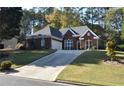Brick ranch house with attached garage and manicured lawn at 1025 Copper Creek Dr, Canton, GA 30114