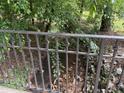 View of a creek from a bridge, with natural rock features and lush greenery at 6054 Nebo Rd, Hiram, GA 30141