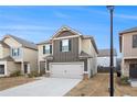 Two-story home with gray garage door and dark trim, neighboring other similar homes at 11948 Brightside Pkwy, Hampton, GA 30228
