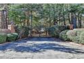 Ornate black gate entrance to a wooded property at 2701 Stilesboro Nw Ln, Acworth, GA 30101