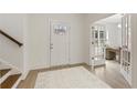 Bright foyer with white walls, wood floors, front door, and open french doors to an office space at 38 Puckett Se Rd, Emerson, GA 30137
