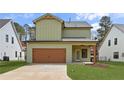 View of the home's exterior featuring a spacious garage with a light green exterior and a well-maintained lawn at 38 Puckett Se Rd, Emerson, GA 30137