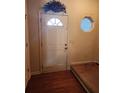 Welcoming front foyer featuring a white front door and a small side window at 424 Village Way, Loganville, GA 30052