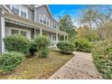 Side view of a two-story home with a porch, beautiful landscaping, and manicured lawn at 36 Latimer Nw Ln, Cartersville, GA 30121