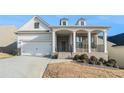 Beautiful home with an inviting front porch, brick accents, and a well-maintained lawn at 5810 Collier Bridge Ln, Hoschton, GA 30548