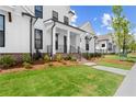 Charming two-story home displaying a well-maintained lawn and black trimmed windows at 509 Pearl St, Cumming, GA 30040