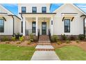 Charming home featuring a brick entry, manicured landscaping, and a welcoming front door at 509 Pearl St, Cumming, GA 30040