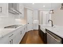 Modern kitchen with white cabinets, quartz countertops, and stainless steel appliances at 509 Pearl St, Cumming, GA 30040