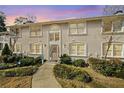 Exterior of a two-story condo building with a landscaped lawn and a pathway leading to the front door at 1538 Chantilly Ne Dr # 224, Atlanta, GA 30324