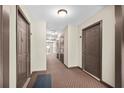 Hallway view of multiple unit doors with doorbells and neutral colored carpet at 1538 Chantilly Ne Dr # 224, Atlanta, GA 30324
