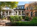 View of home's back showing the porch and landscaping at 703 Hammond Dr, Woodstock, GA 30188