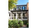 Home's rear elevation, showcasing the porch and landscaping at 703 Hammond Dr, Woodstock, GA 30188