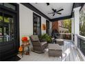Relaxing front porch with ceiling fan and seating at 703 Hammond Dr, Woodstock, GA 30188
