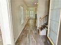 Inviting entryway with wood-look flooring and staircase at 3978 Lake Manor Way, Atlanta, GA 30349