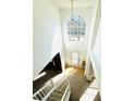 Bright foyer with a soaring window, light wood floors, and a grand staircase with white banisters at 2717 Kristen Ct, Conyers, GA 30012