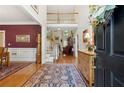 Grand foyer featuring hardwood floors, high ceilings, staircase and an open view to the living spaces at 1400 Lamont Cir, Dacula, GA 30019