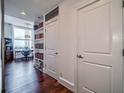 Hallway view leading to a study area with built in bookshelves and wood flooring at 57 Forsyth Nw St # 12B, Atlanta, GA 30303