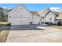 Two-car garage and front entrance of craftsman style home at 276 Villa Grande Dr, Locust Grove, GA 30248