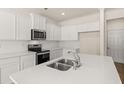 Beautiful kitchen features white countertops, stainless steel appliances, and a modern faucet at 345 Sound Cir # 134, Stockbridge, GA 30281