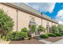 Row of brick townhouses with gray roofs and landscaping at 6980 Roswell Rd # J6, Atlanta, GA 30328