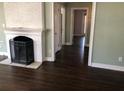 Living room with hardwood floors and a fireplace, leading to a hallway at 148 Murray Hill Ne Ave, Atlanta, GA 30317