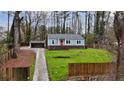 Beautiful light blue house with red door, carport, and well-manicured lawn at 589 Northern Ave, Clarkston, GA 30021