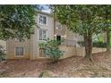 Tan two-story house with many windows and a sloped front yard at 10 Braemore Dr, Sandy Springs, GA 30328