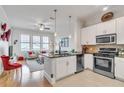 Open-concept kitchen flows into a cozy living area with abundant natural light at 3621 Vinings Slope Se # 1537, Atlanta, GA 30339