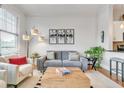 Comfortable living room with plush seating, wooden floors, and large windows providing ample natural light at 3621 Vinings Slope Se # 1537, Atlanta, GA 30339