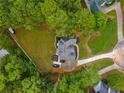 Aerial view of house, driveway, and large backyard surrounded by trees at 3545 Silver Vista Ct, Cumming, GA 30041