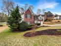 Lovely two-story brick home with landscaped front yard and an attached two-car garage at 1615 Cheshire Ct, Lawrenceville, GA 30043