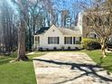 Charming home with white siding, black shutters, and a concrete driveway at 2035 Marbut Trce, Lithonia, GA 30058