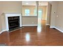 Living room with hardwood floors, fireplace, and access to the backyard at 650 Providence Sw Pl, Atlanta, GA 30331