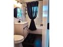 Stylish bathroom with modern fixtures, patterned tile, dark accents, and a sleek vanity at 2161 Penelope Nw St, Atlanta, GA 30314