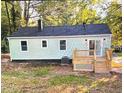 Rear view of a home with a small deck and backyard, showcasing the siding and roof at 2161 Penelope Nw St, Atlanta, GA 30314