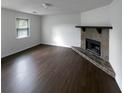 Spacious living room featuring a stone fireplace, hardwood floors, and a large window at 5942 Rock Court #5, Union City, GA 30291