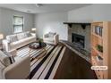 Bright living room boasts a stone fireplace, hardwood floors, and stylish neutral furnishings at 5942 Rock Court #5, Union City, GA 30291