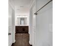 Hallway view of a bathroom with a dual sink vanity and dark wood cabinets at 3270 Forest Green Dr, Douglasville, GA 30135