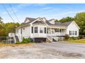 White house with wrap around porch, driveway, and fenced yard at 1553 Alcovy Rd, Lawrenceville, GA 30045