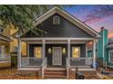 Charming dark gray one-story home with a welcoming front porch, white trim, and brick-lined steps at 400 Bass Sw St, Atlanta, GA 30310