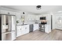 Modern kitchen with white shaker cabinets, stainless steel appliances, and quartz countertops at 2746 King Arthur Ct, Buford, GA 30519