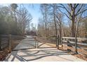 Long driveway leading to a modern home with automatic gates at 600 Jones Rd, Roswell, GA 30075