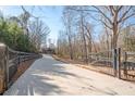 Long driveway leading to a modern home with automatic gates at 600 Jones Rd, Roswell, GA 30075