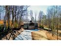 Modern home exterior with a large driveway and wooded setting at 600 Jones Rd, Roswell, GA 30075