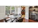 Dining room with modern table set and view into the kitchen at 29 La Rue Nw Pl, Atlanta, GA 30327